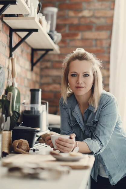 Belle femme blonde à la maison