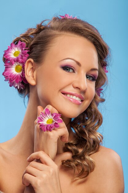 Belle femme caucasienne avec des fleurs dans les cheveux