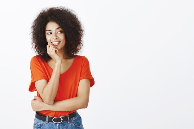 belle femme avec une coiffure afro posant en studio