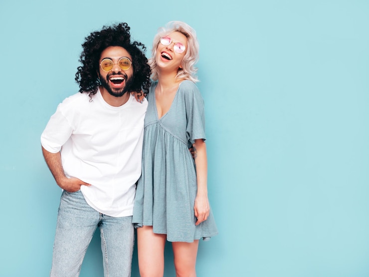 Photo gratuit belle femme souriante et son beau petit ami famille multiraciale joyeuse et sexy ayant des moments tendres sur fond beige en studio