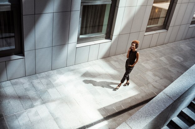 Belle femme, sourire, conversation téléphone, marche bas, ville