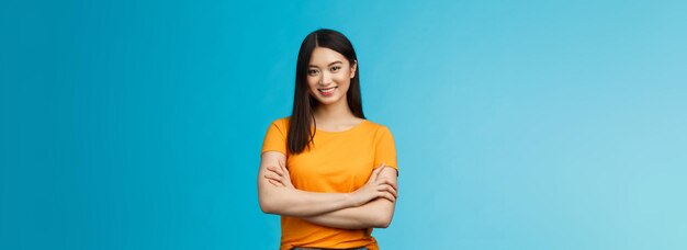 Belle fille asiatique confiante et affirmée avec une coiffure courte sombre bras croisés sur la poitrine re