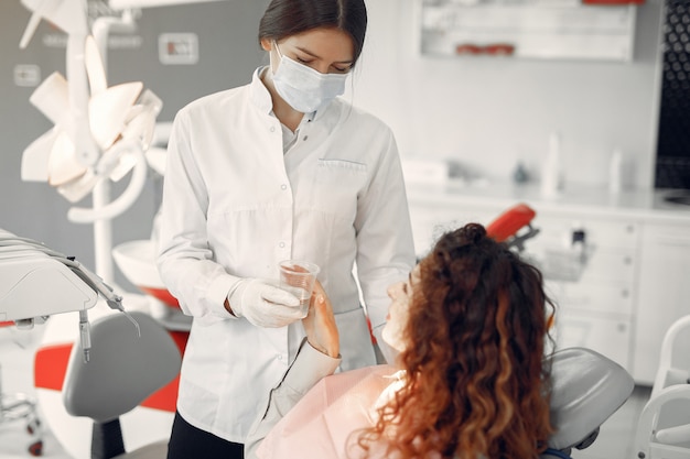 Belle fille assise dans le bureau du dentiste