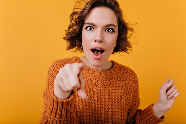 Belle fille blanche avec un maquillage décontracté posant avec excitation