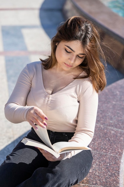 Belle fille lisant son livre au parc Photo de haute qualité