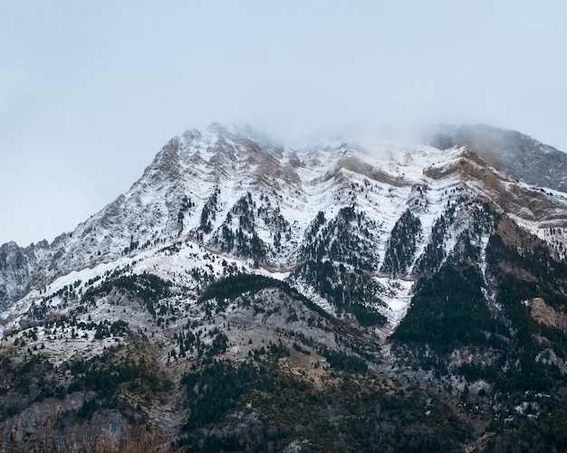 Belle gamme de hautes montagnes rocheuses couvertes de neige pendant la journée