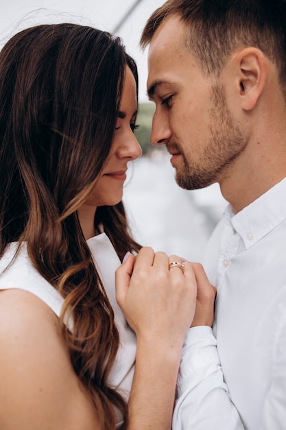 Belle jeune couple weddign bisous et câlins sous un parapluie en sombre journée d&#39;été