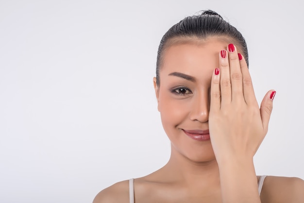 Belle jeune femme couvre le visage avec les mains