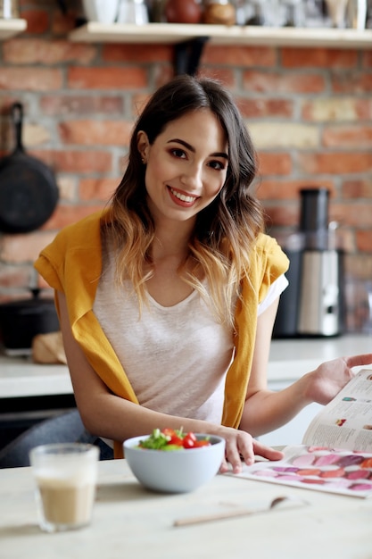 Belle jeune femme mangeant une salade saine