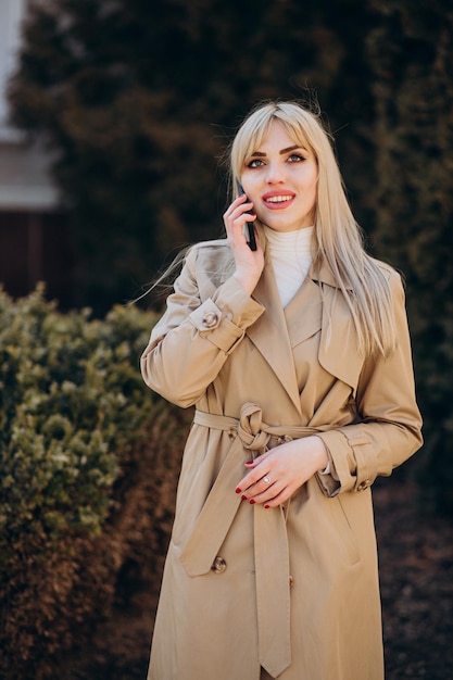 Belle jeune femme en manteau beige