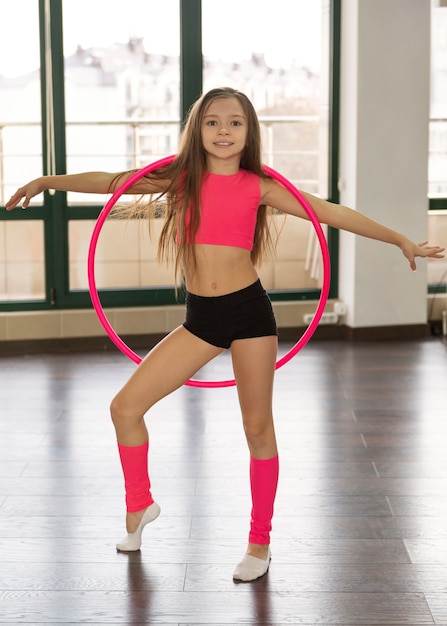 Belle jeune fille à l'aide de hula hop