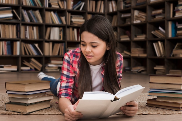 Belle jeune fille étudie à la bibliothèque