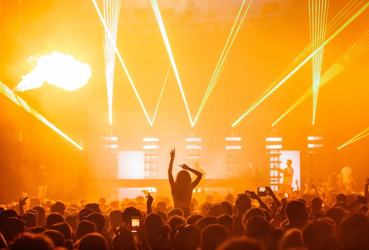 Photo gratuit belle photo d'un concert en direct avec un spectacle de lumière jaune et une grande foule en liesse