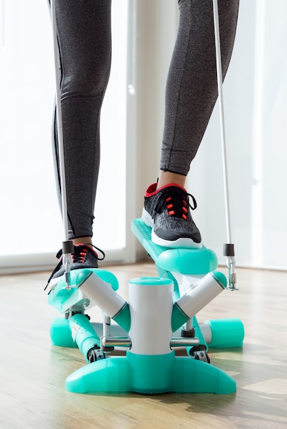 Belle sportive jeune femme faisant de l&#39;exercice en salle de gym.