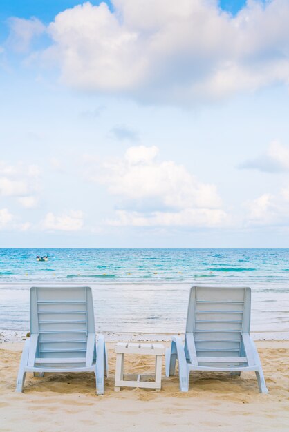 Belles chaises de plage sur blanc tropical plage de sable