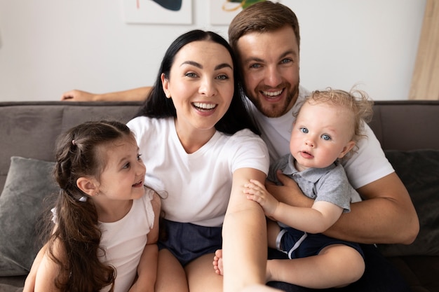 Belles personnes ayant un appel vidéo avec leur famille à la maison