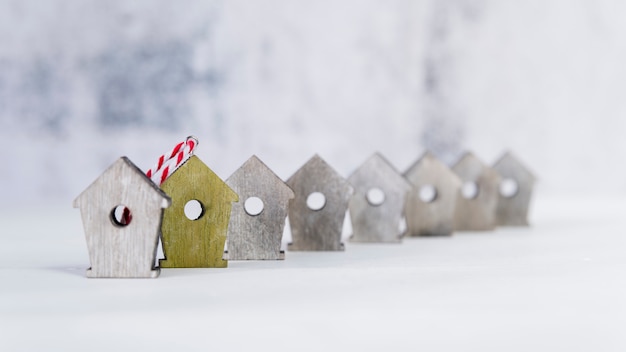 Birdhouse jaune se démarquant des autres maisons d&#39;oiseaux blancs sur fond blanc