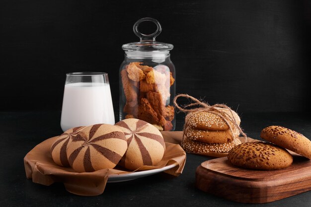 Biscuits au cacao, sésame et cumin avec un verre de lait.