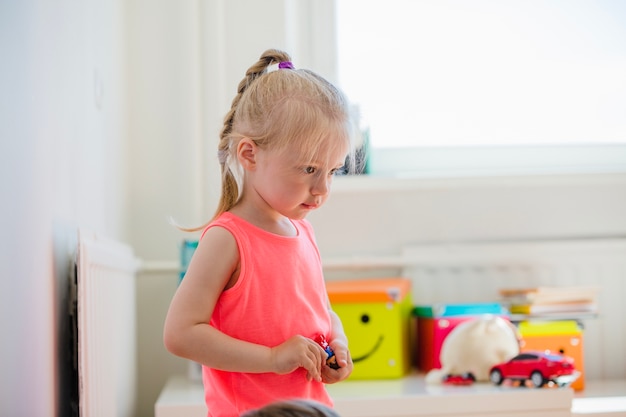 Blonde girl holding toy