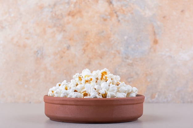 Bol de pop-corn salé pour une soirée cinéma sur fond blanc. photo de haute qualité