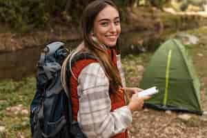 Photo gratuite bonne fille de camping dans la forêt et la vue de la tente