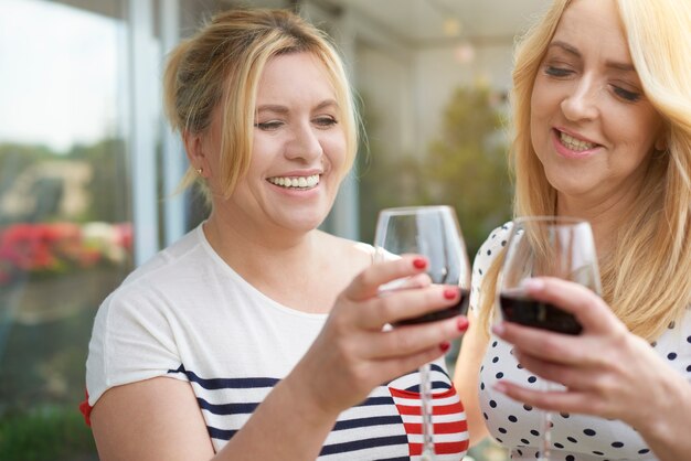 Bouchent le portrait de femmes vin sur le balcon