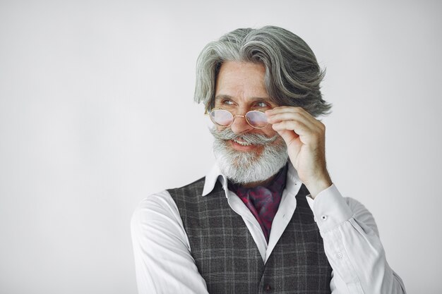 Bouchent le portrait d'un homme démodé souriant. Grand-père avec une horloge.