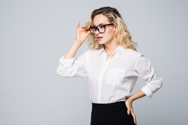 Bouchent le portrait d'une jeune femme émotionnelle portant des lunettes isolées sur un mur gris.