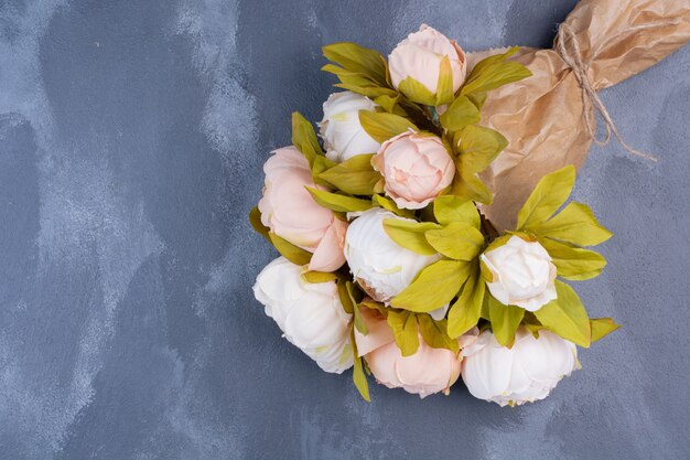 Bouquet de fleurs artificielles sur bleu.