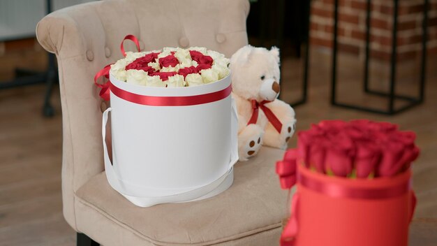 Bouquet de fleurs sur une chaise pour célébrer l'événement de la saint-valentin dans une salle vide. Roses rouges et cadeaux romantiques dans l'espace, surprise décorative pour montrer l'amour, l'affection et la passion. Fermer