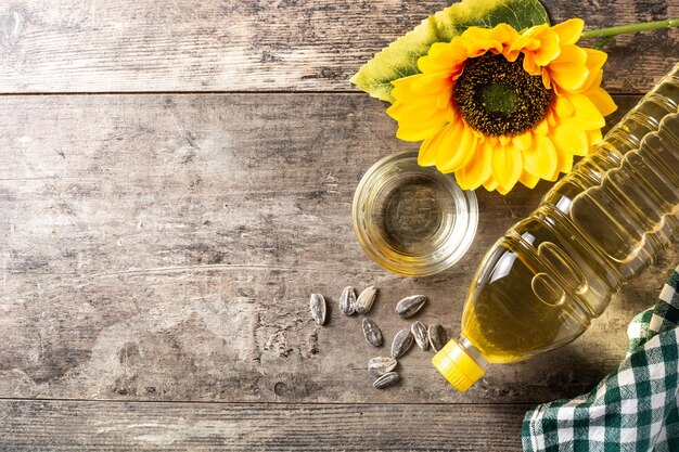 Bouteille en plastique d'huile de tournesol sur table en bois