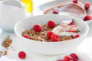 Photo gratuite bowl avec du yogourt, les céréales et les framboises