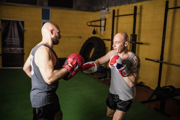 Boxeurs pratiquant la boxe dans le studio de fitness