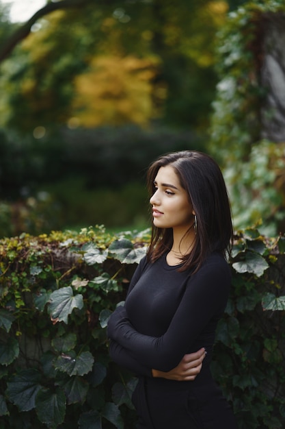 brunette fille marchant dans le parc en automne