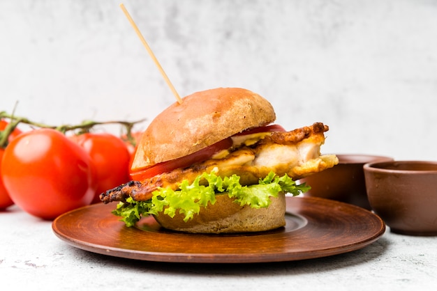 Photo gratuite burger savoureux à côté de tomates