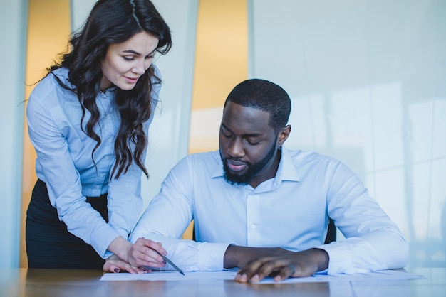 Business man and woman checking document