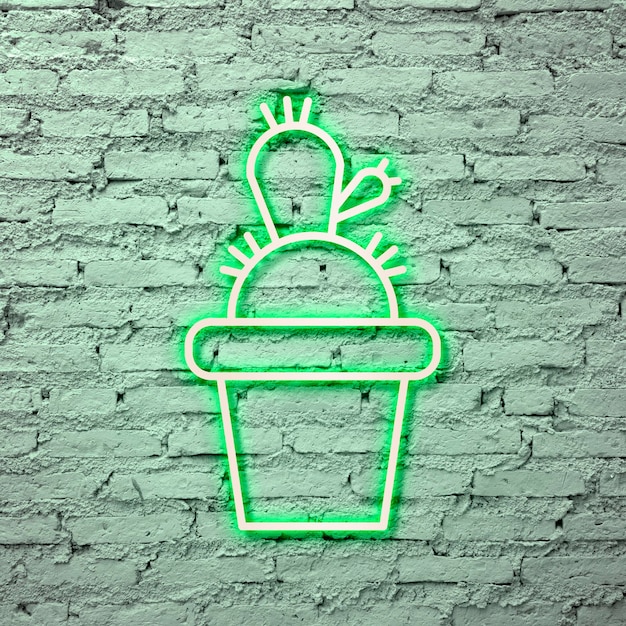 Photo gratuite cactus vert fluo sur un mur de briques