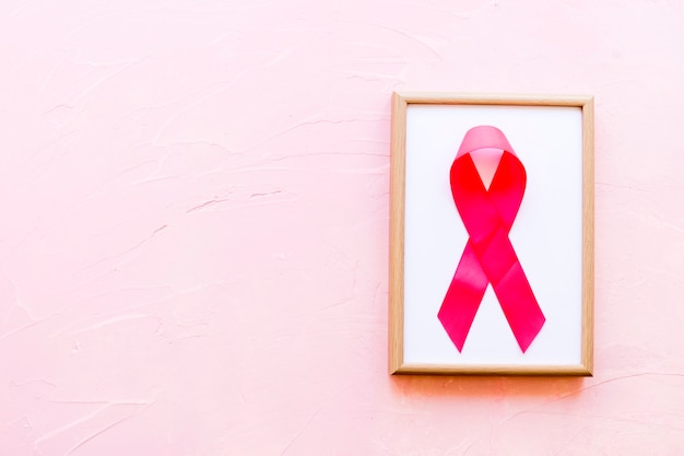 Cadre blanc en bois avec ruban rose de sensibilisation au cancer du sein