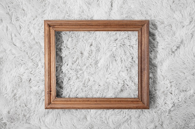 Photo gratuite cadre en bois vue de dessus sur tapis