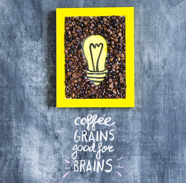 Cadre jaune ampoule et grains de café avec texte sur tableau noir