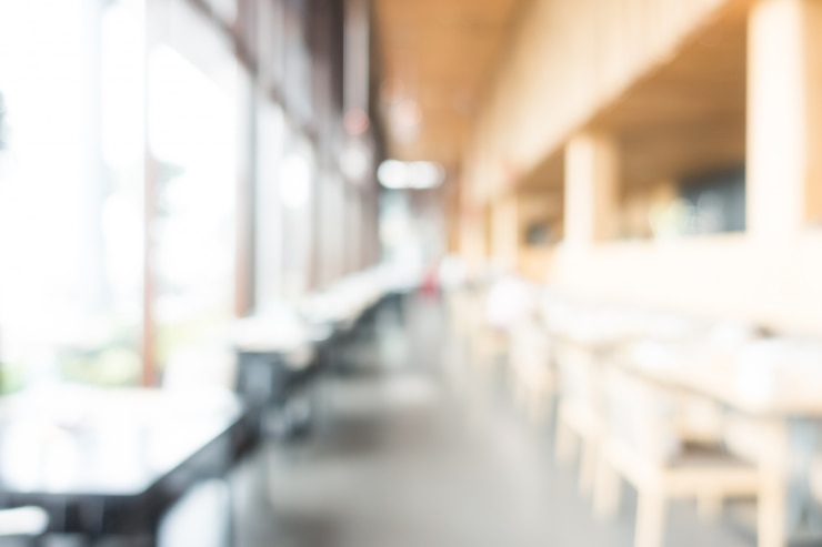 Photo gratuit cafe brouillé avec des tables et des chaises en bois