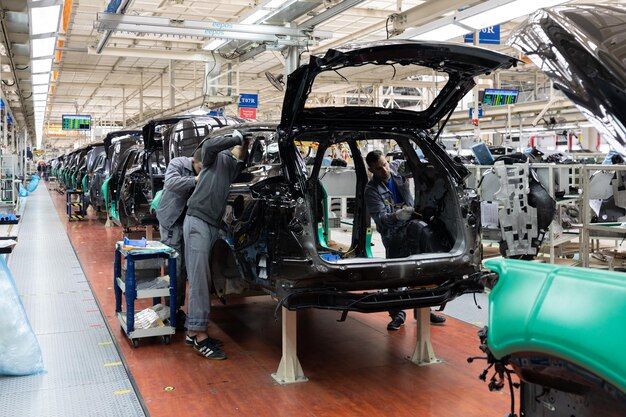 Les carrosseries sont sur la chaîne de montage Usine de production de voitures Industrie automobile moderne Une voiture en cours de vérification avant d'être peinte dans une entreprise de haute technologie