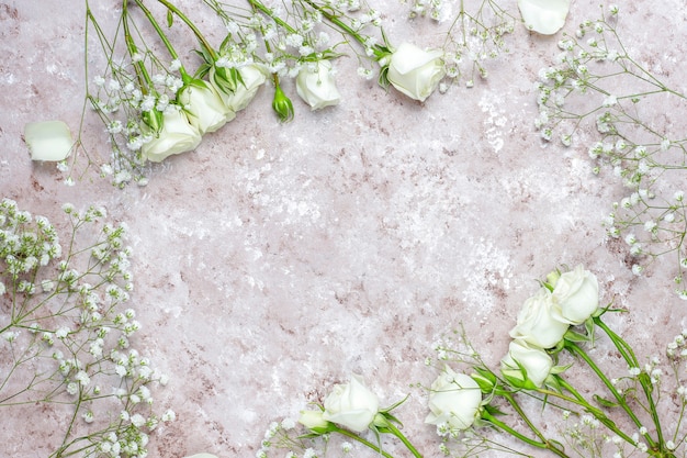Carte de printemps avec des roses blanches et des fleurs, vue de dessus