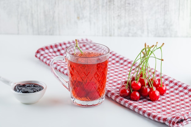 Cerise au thé, confiture, torchon de cuisine vue latérale