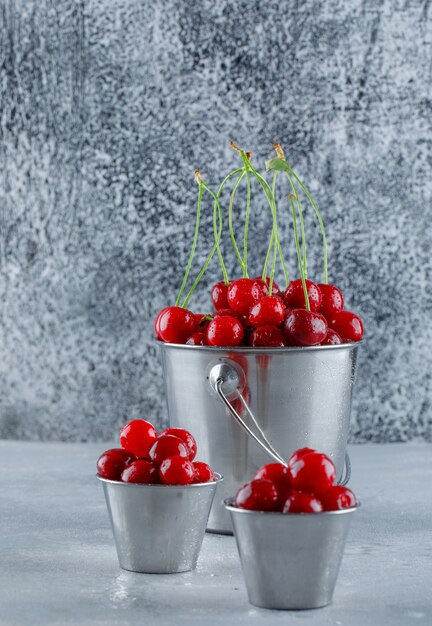 Cerises dans des seaux. vue de côté.