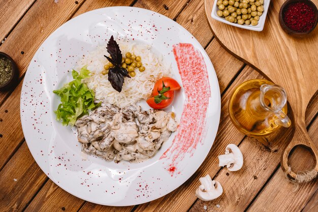 Champignon crémeux servi avec du riz garni de petits pois et de laitue