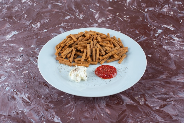 Chapelure avec sauces sur une assiette , sur la table en marbre.