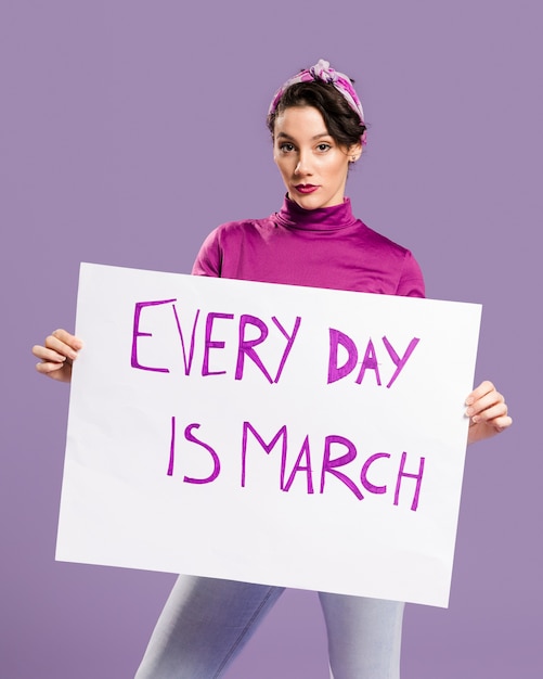 Photo gratuite chaque jour est un carton de mars avec une femme tenant le tableau