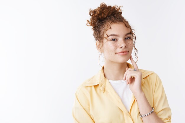 Charmante tendre belle jeune femme rousse aux cheveux bouclés mignonne taches de rousseur choisissant de nouveaux produits cosmétiques de soin de la peau assistant de conseil en centre commercial debout réfléchi faire un choix