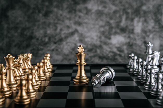 Échecs d’or et d’argent sur le jeu d’échecs pour le concept de leadership métaphore de l’entreprise